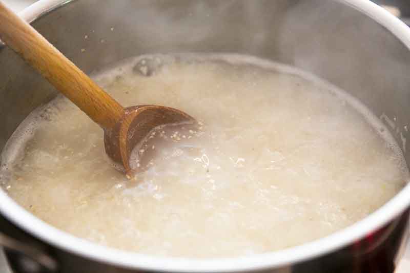 stirring grits in pot