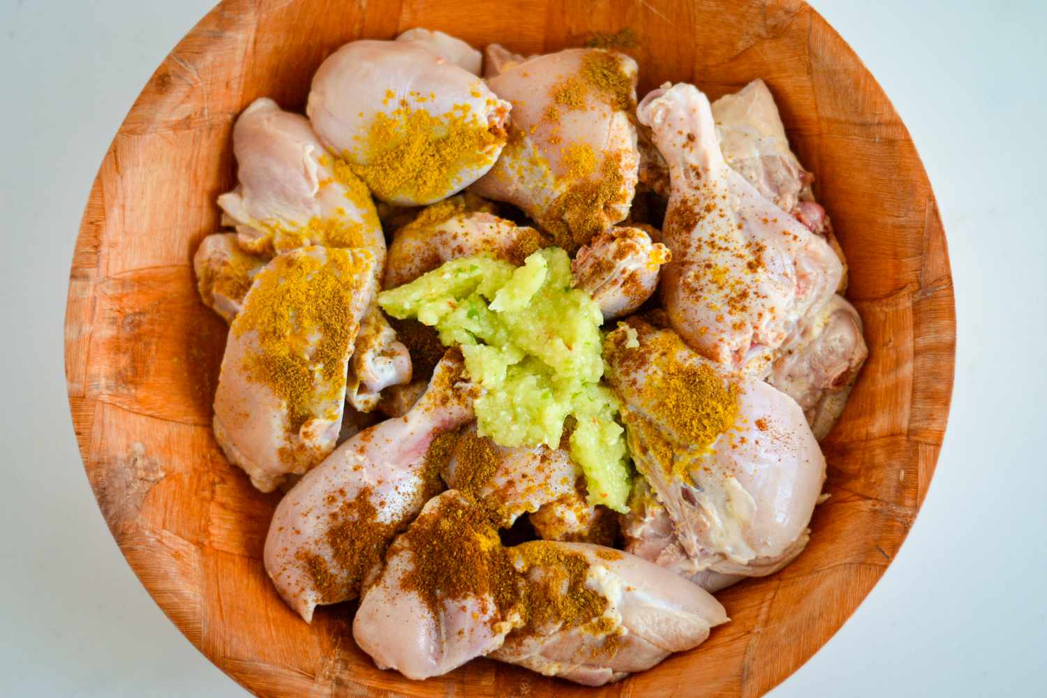 Spices and Green Seasoning Added to Chicken for Curry Recipe