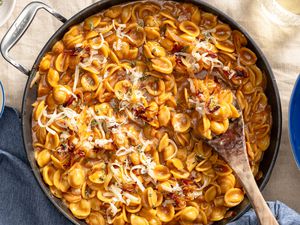 French onion pasta in a pot at a table