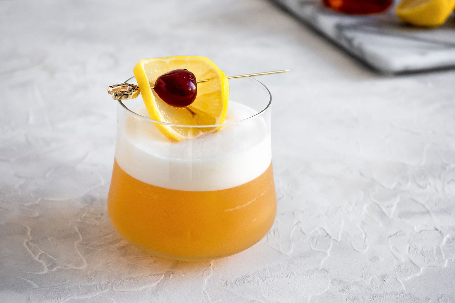 Amaretto Sour Garnished with Cherry and Lemon Slice