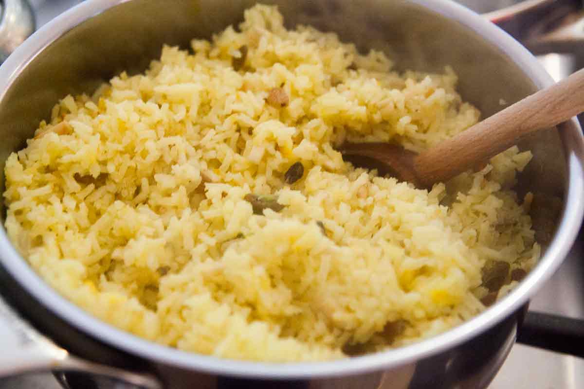 Saffron rice being mixed together in cooking pot