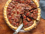 Chocolate pecan pie with bourbon with a couple slices cut.