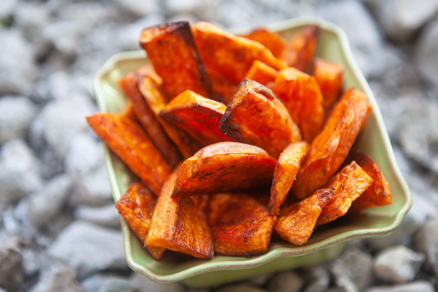 Sweet potato fries stacked in a container.