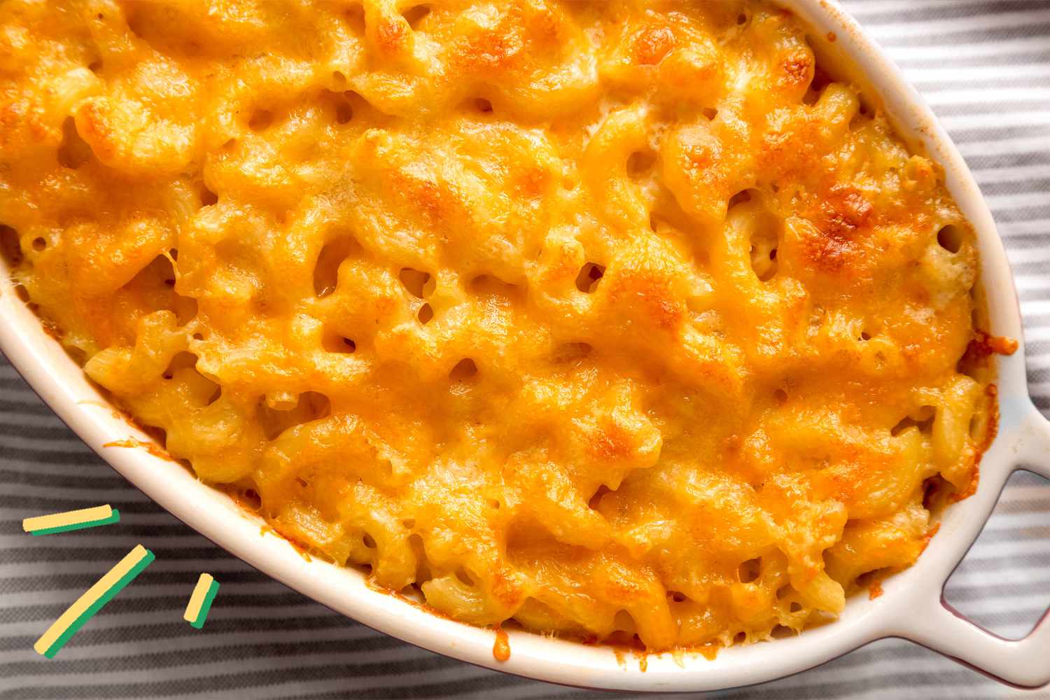 Photo of baked macaroni and cheese with some yellow and blue illustration on the corner of the picture