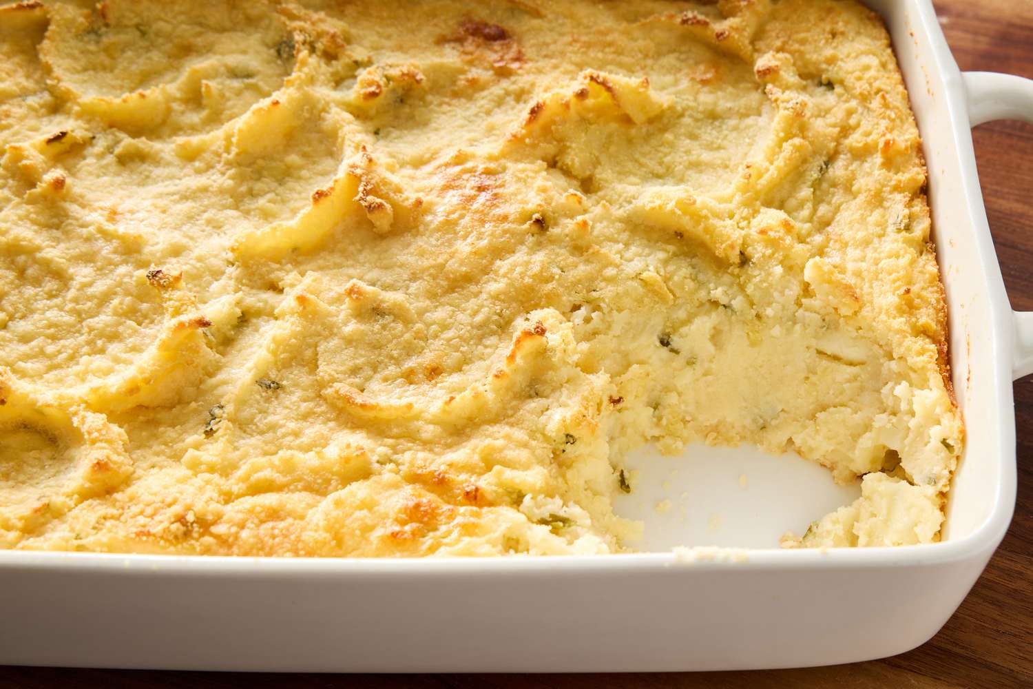 Mashed Potato Casserole in a dish with one serving scooped out