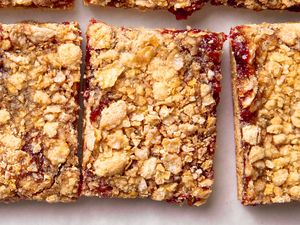 Crispy topped raspberry jam bars arranged in close up view