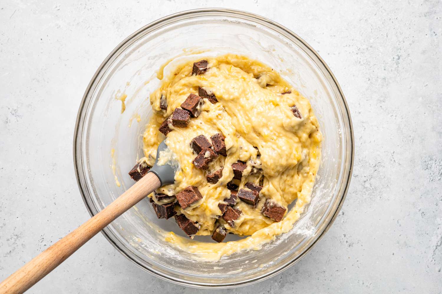 Brownie Pieces Mixed into Bowl of Banana Bread Batter 