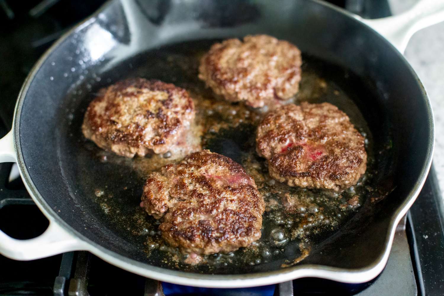 Cooked Burgers on a Cast Iron Skillet
