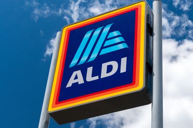 ALDI sign against a blue sky