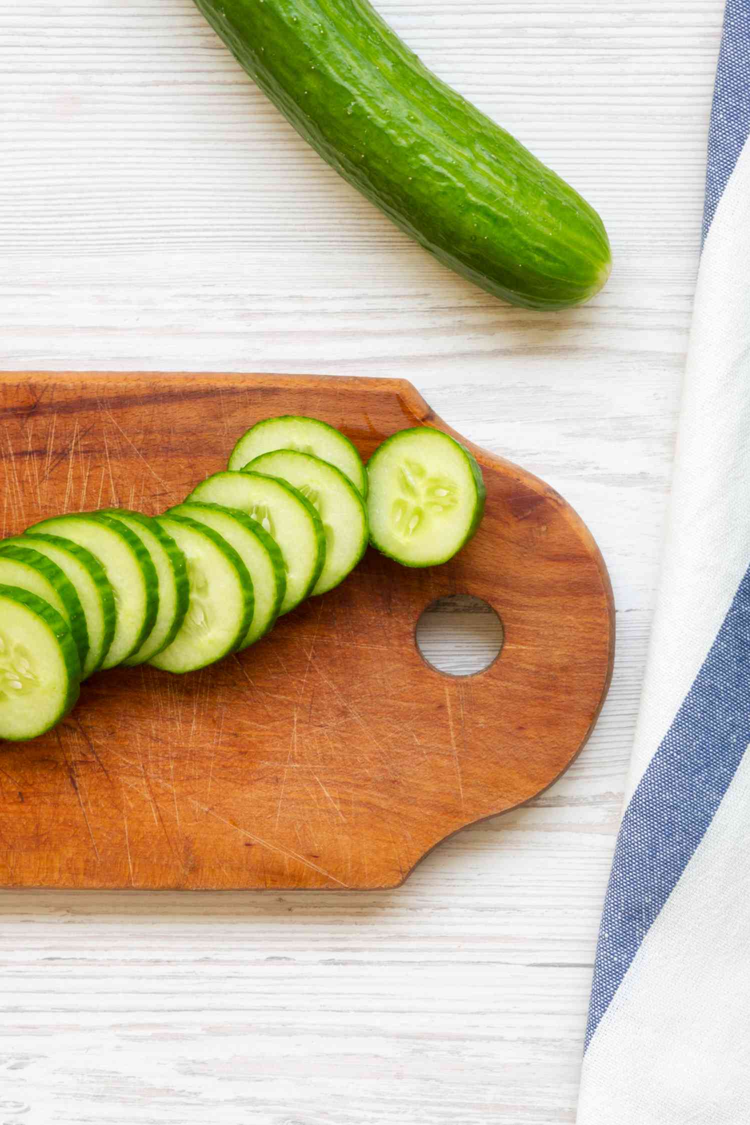 cucumbers sliced on a cutting board