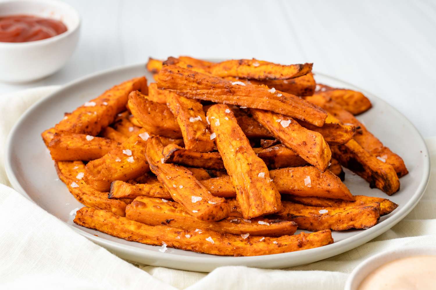 Side view of a platter of homemade sweet potato fries.