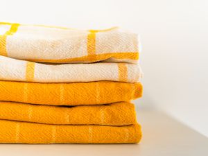 Yellow kitchen towels folded in a neat stack