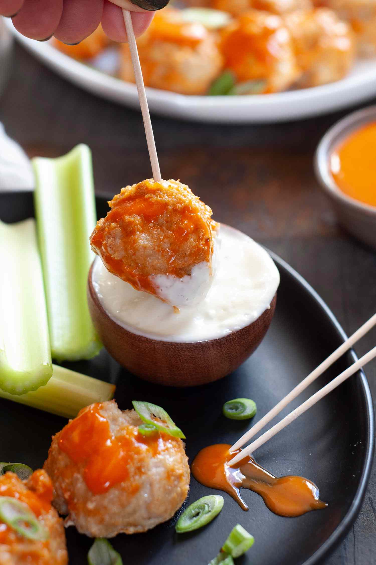Buffalo chicken meatball dipped in blue cheese.