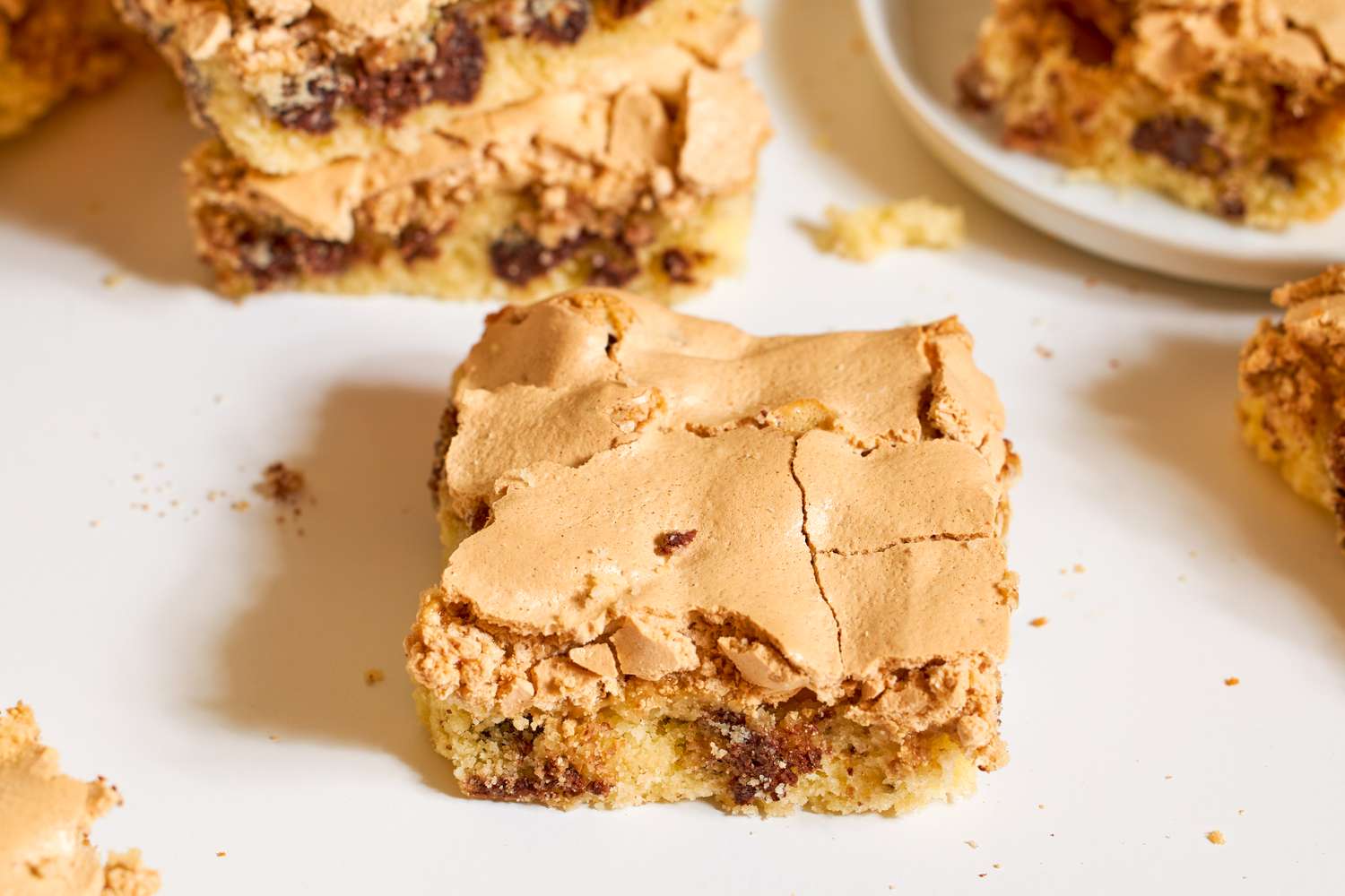 Dessert bars with a meringue top and visible chocolate chips