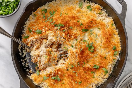 A cast iron skillet with nicely browned baked french onion beans
