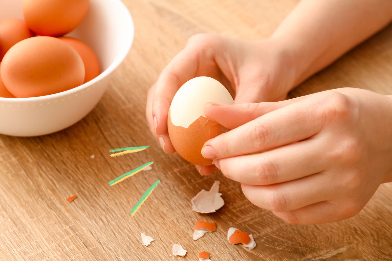 Someone peeling hard boiled eggs