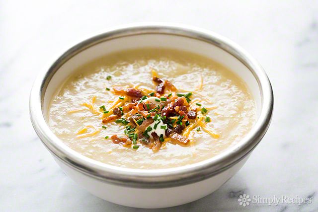 Baked Potato Soup in serving bowl with cheese, onions and bacon