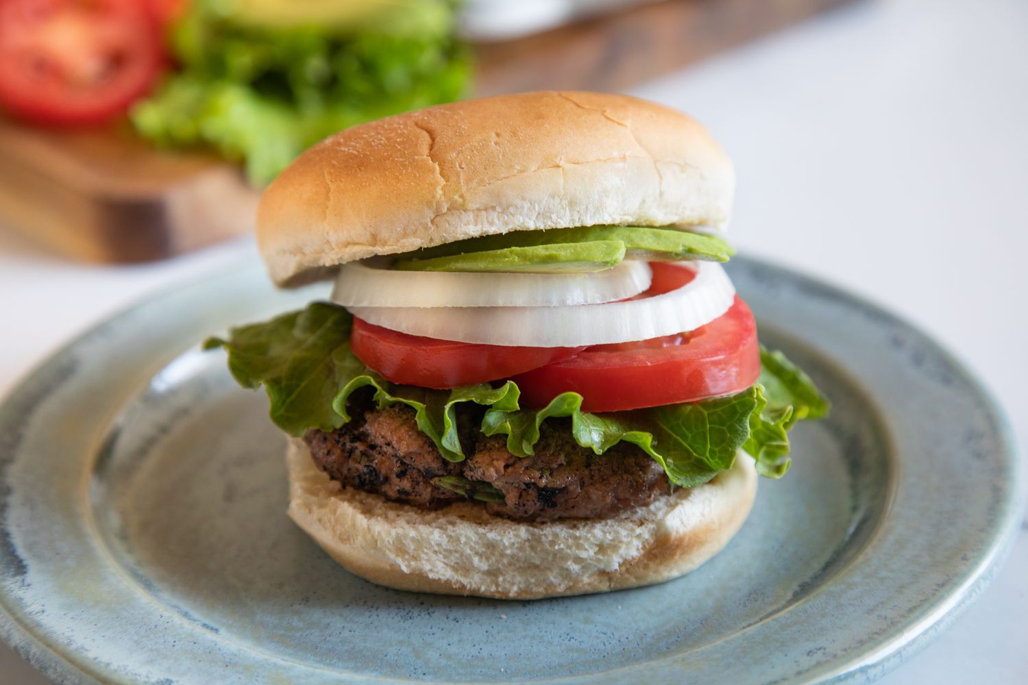 Side view of a hamburger with toppings.