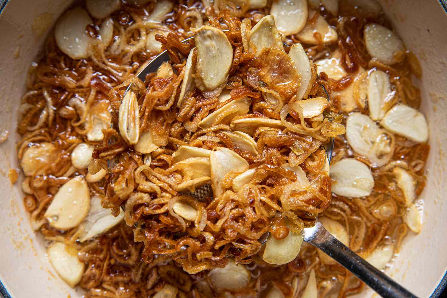Golden Brown Fried Garlic and Shallots Removed from Pot of Oil