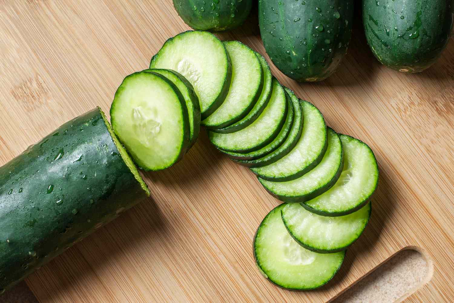sliced cucumbers on a cutting board