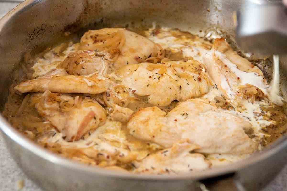 dijon chicken being cooked in pot