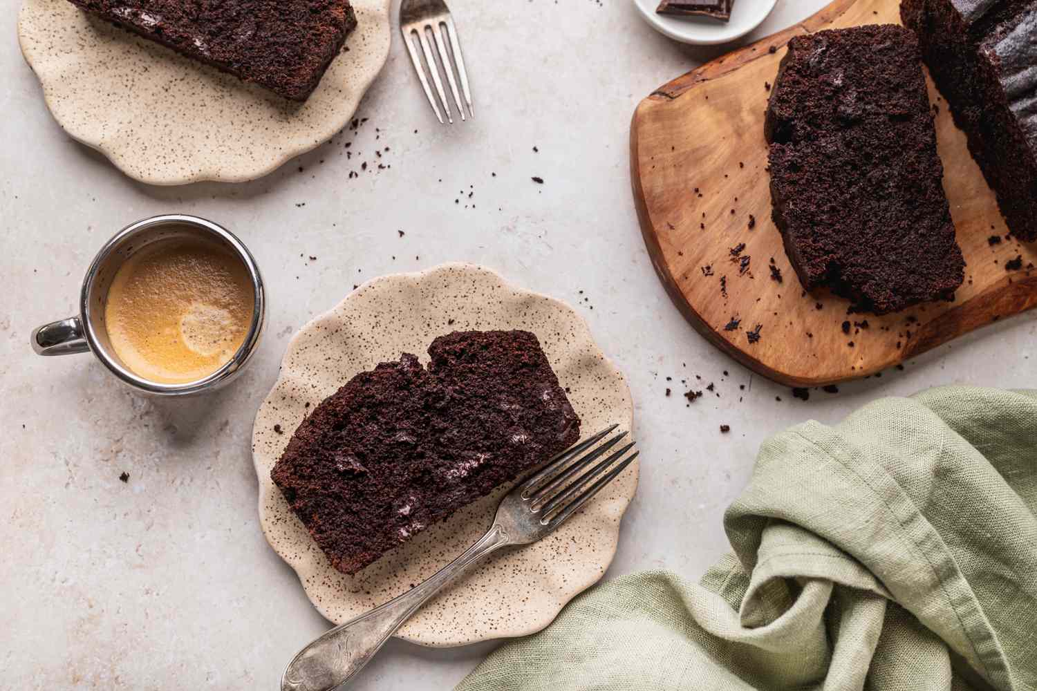 Sliced chocolate pound cake with a cup of coffee.