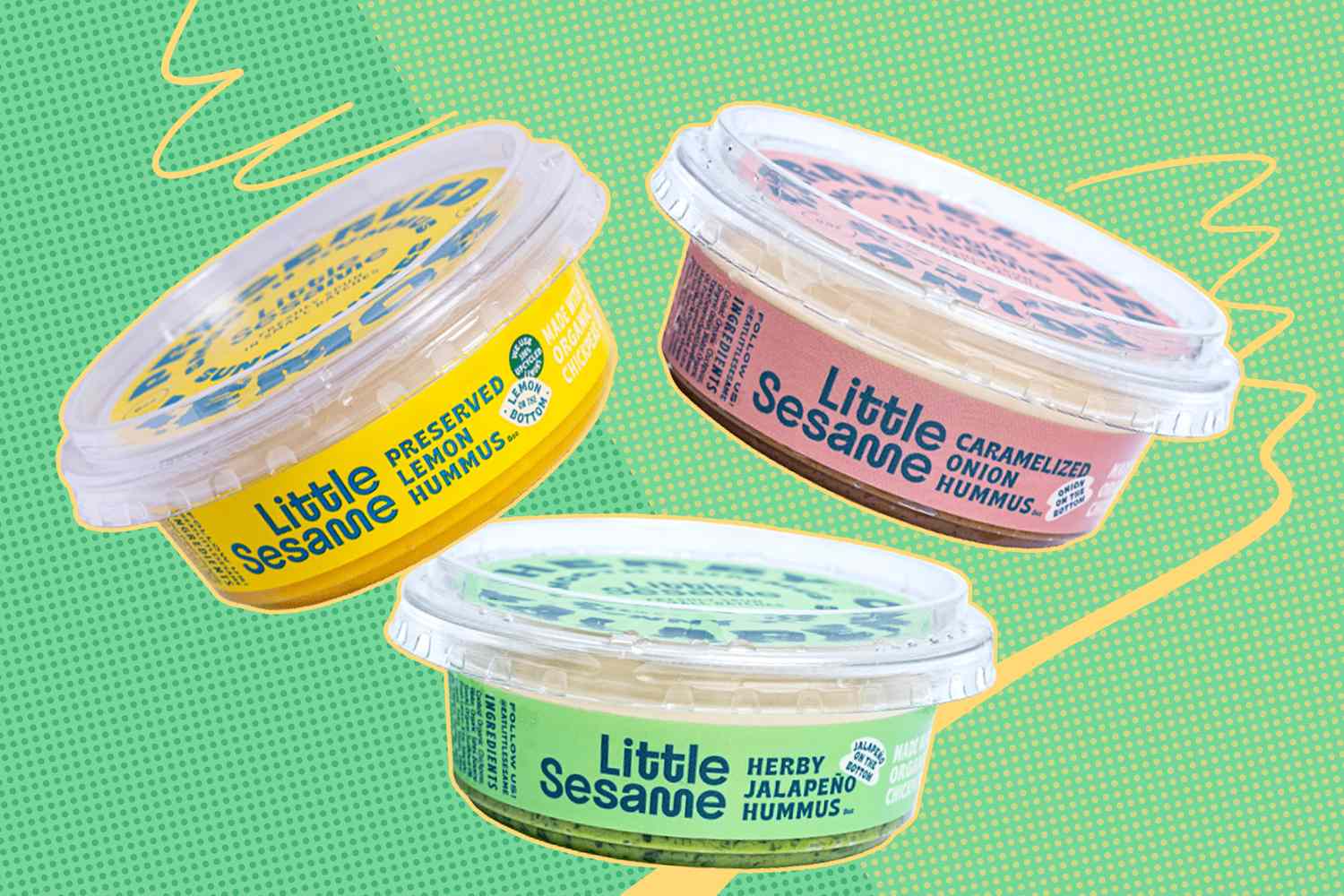 Three tubs of Little Sesame hummus in different flavors on a green background