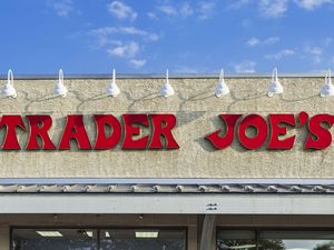 Trader Joes storefront sign wallmounted featuring the name in red letters