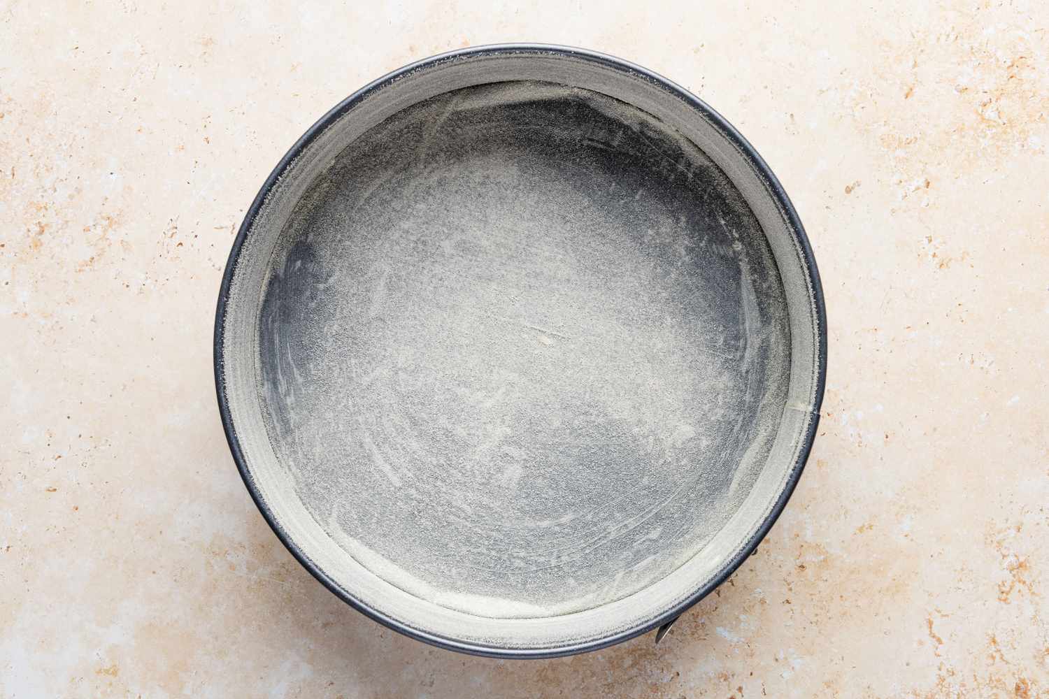 cake pan prepped - flour added for Migliaccio (Italian Ricotta and Semolina Cake)