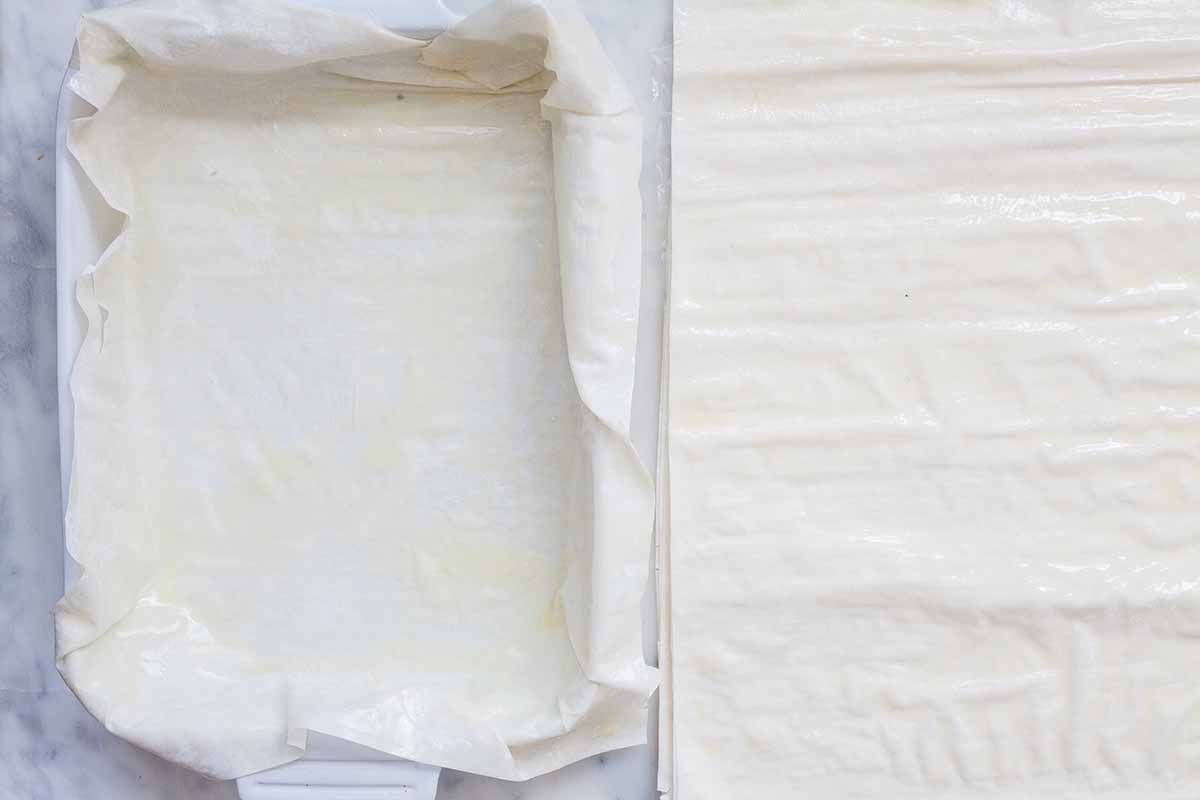 Phyllo lining a casserole dish for spanakopita.