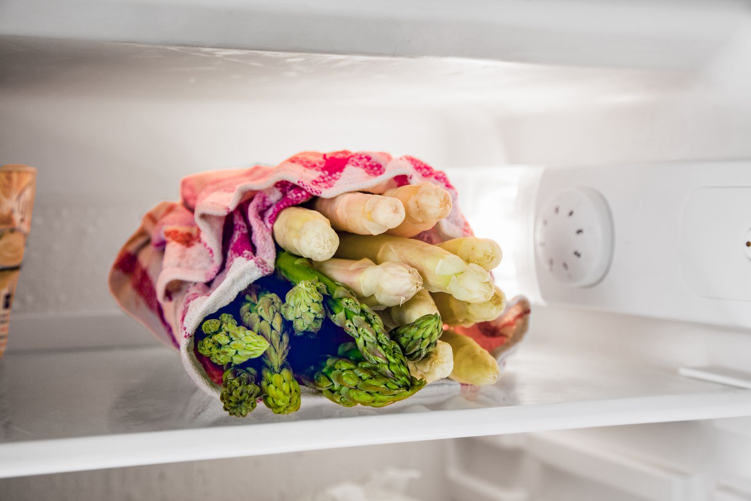 Asparagus on a refrigerator shelf