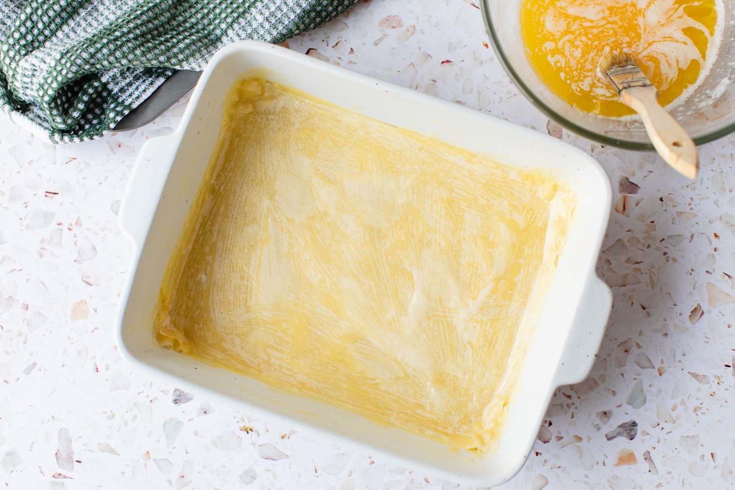 Eight Layers of Phyllo Dough in a Casserole Dish Brushed with Melted Butter