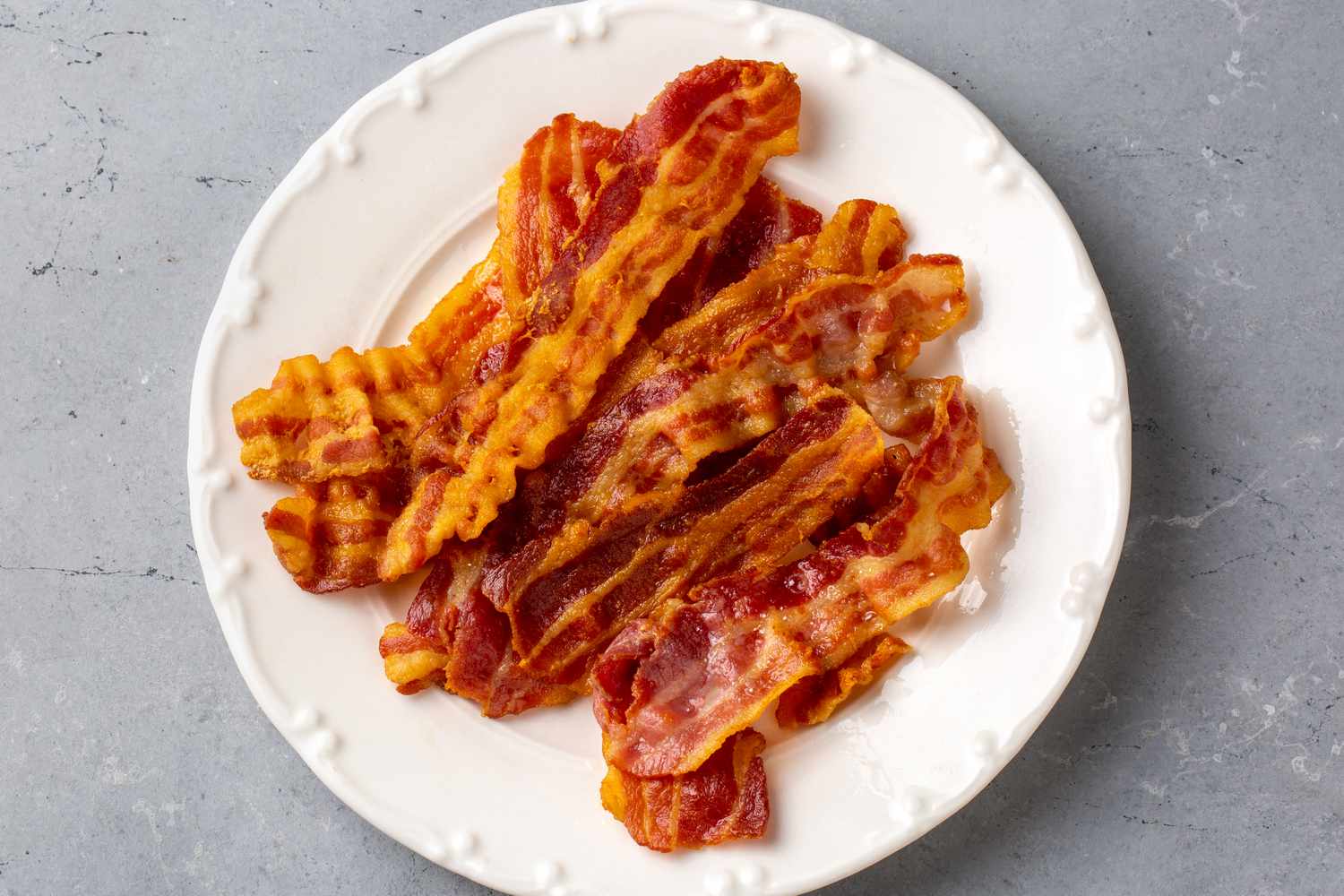 Crispy fried bacon on a white plate