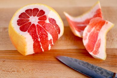Citrus with Some of the Rind Cut Off and on the Counter, a Knife and Citrus Rinds