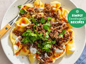 A plate of pasta shells topped with ground meat and garnished with parsley with the label Simply Recipes Weeknight visible