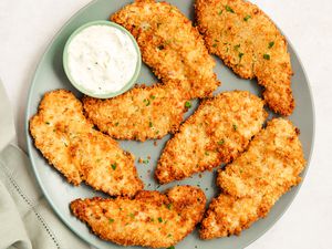 Air Fryer Chicken Tenders on a plate with ranch dip in a cup