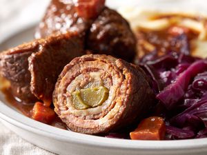 German rouladen on a plate with cabbage and potatoes and gravy