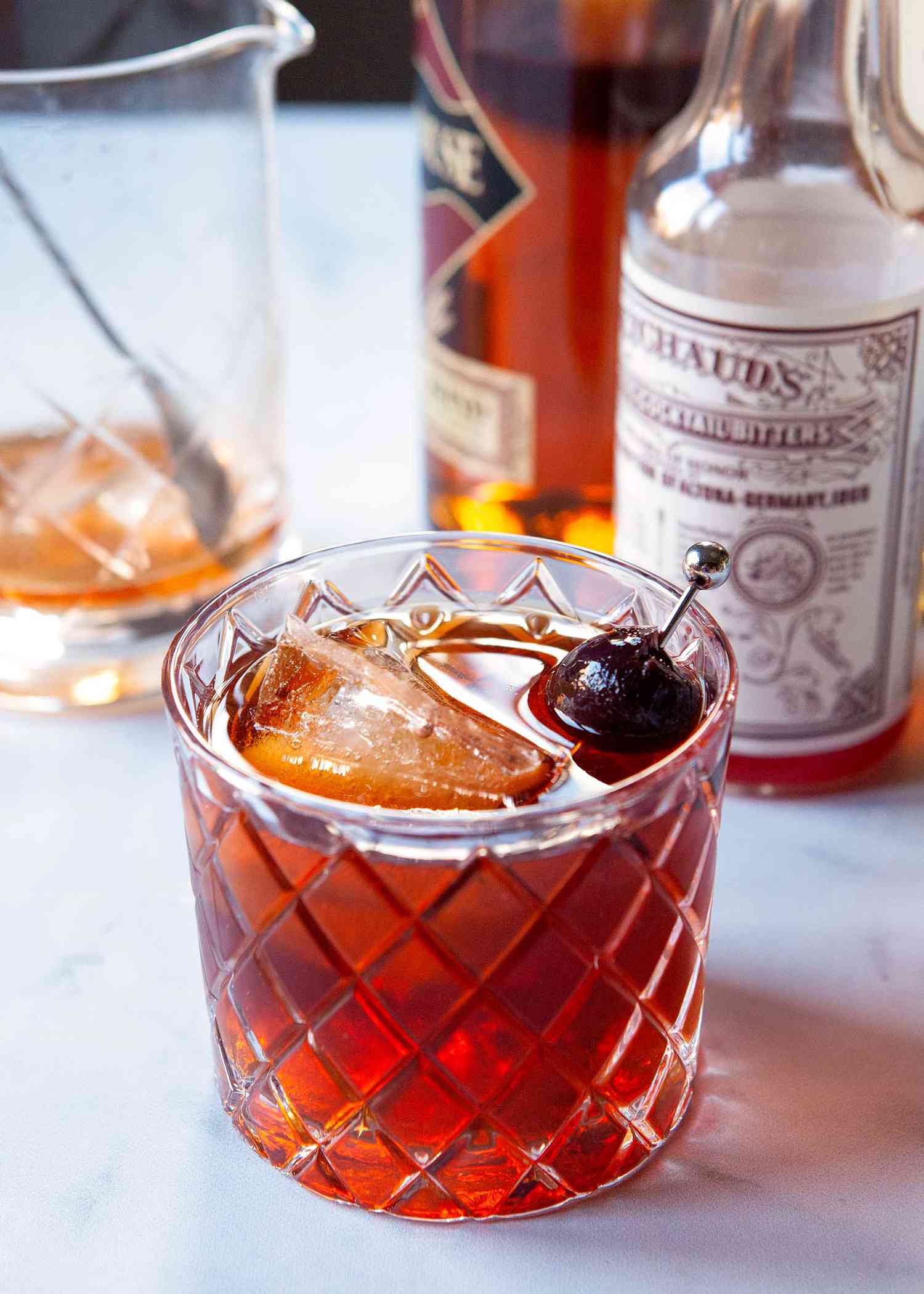 A Vieux carre is set in front of ingredients to make the cocktail.