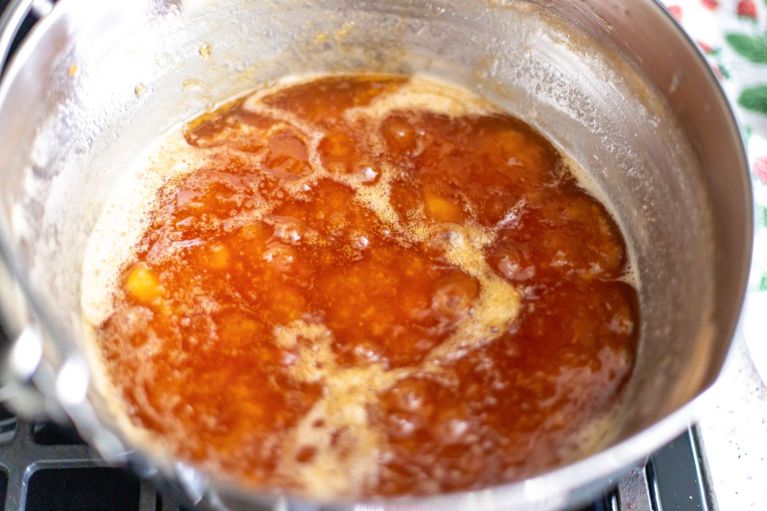 Peach and Pineapple Jam Boiling on the Stove in a Pot