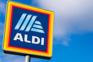 Aldi store sign against a cloudy blue sky