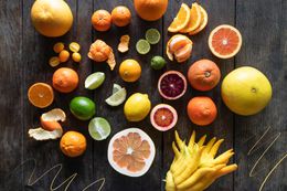 Citrus varieties on dark wood background