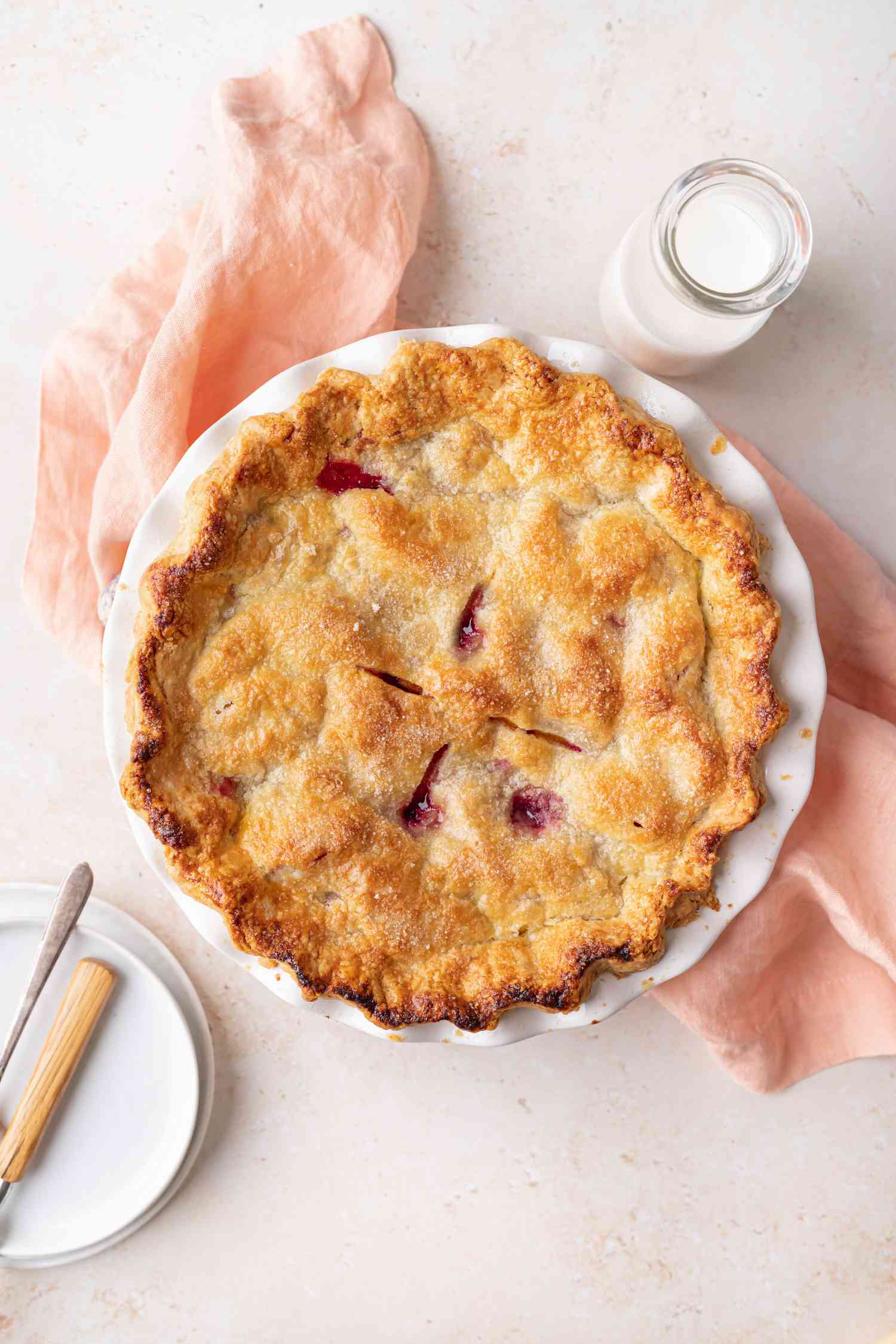 Overhead view of a summer peach and raspberry pie.