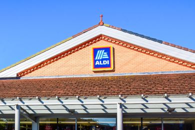 The facade of an Aldi store with the brand name displayed prominently on the building