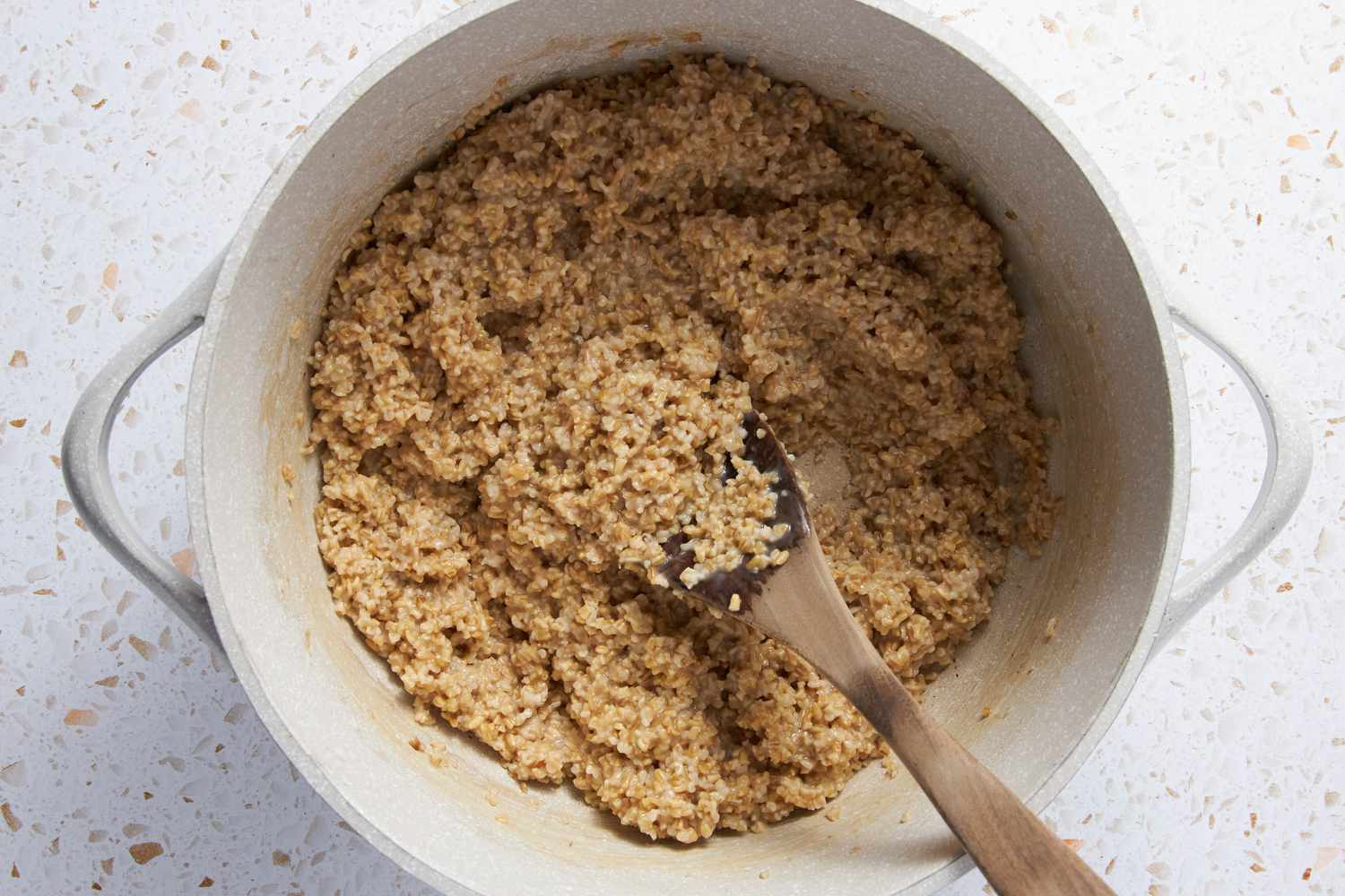 Oats in a Dutch Oven, Stirred With a Wooden Spoon