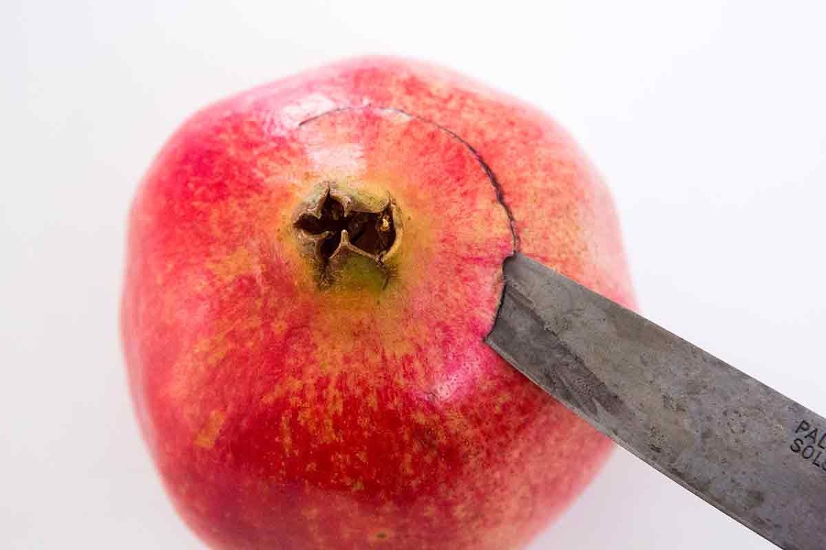 how to cut a pomegranate step 2 - cut around blossom end