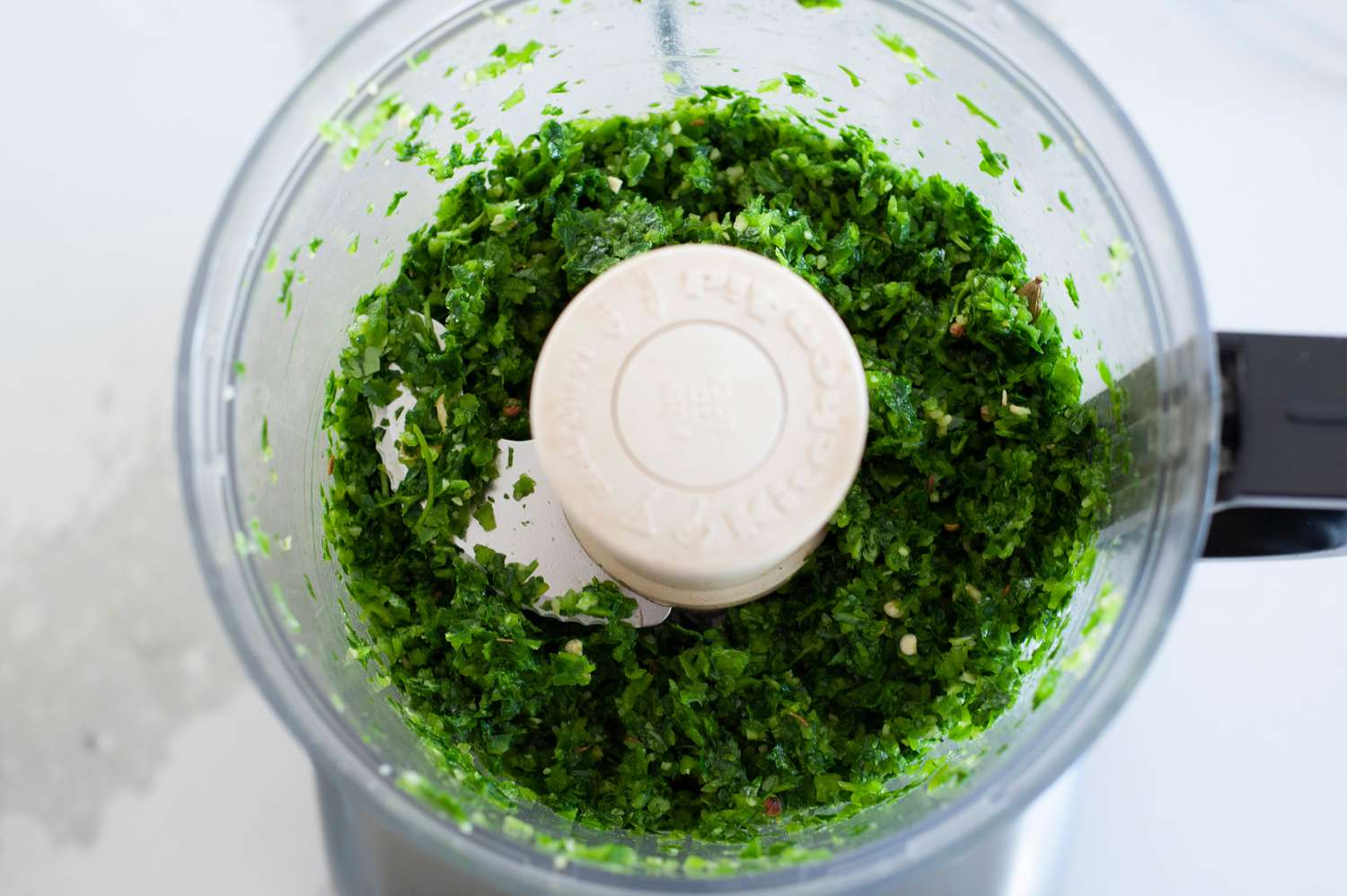 Herbs processed in food processor. 