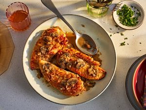 Platter of chicken marsala on a kitchen counter