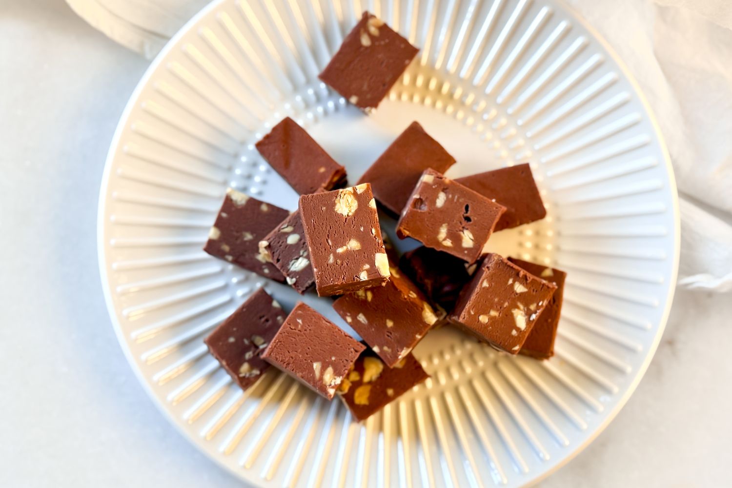 overhead view of a plate of Mamie Eisenhower’s Million Dollar Fudge cut into pieces