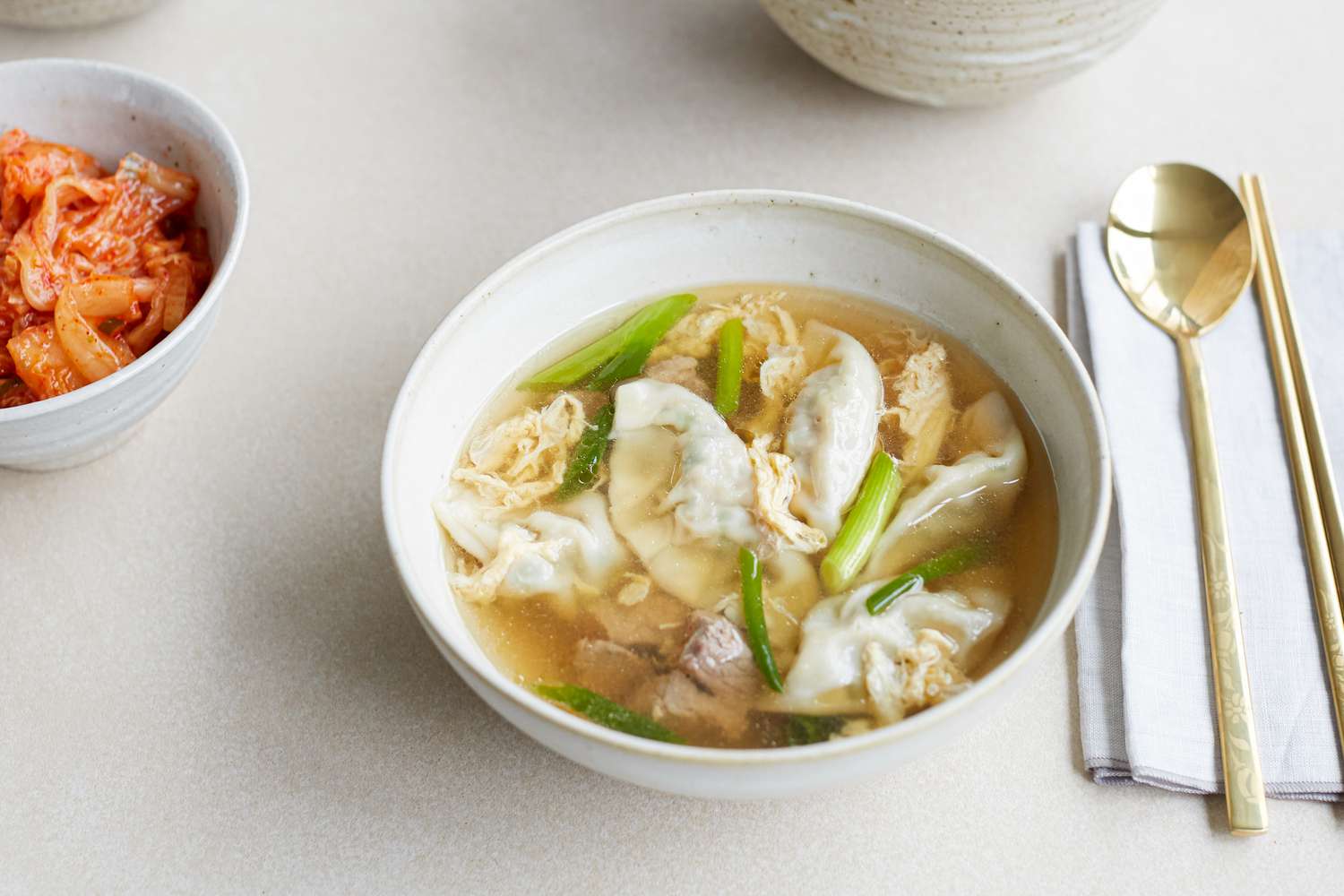 Overhead view of a bowl of beef soup with dumplings.