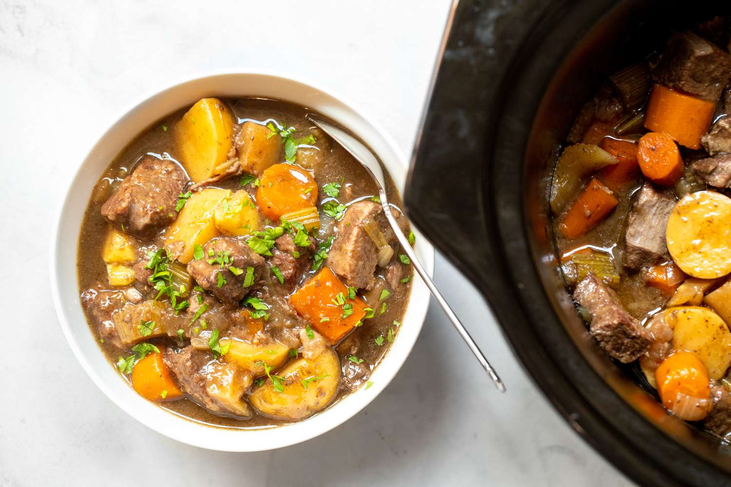 Bowl of Beef Stew Next to a Slow Cooker